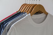 Load image into Gallery viewer, A rack of T-Shirts
